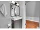 Modern bathroom vanity with a large mirror and view into the next room at 1208 S Pennsylvania St, Denver, CO 80210