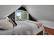 This bedroom has a sloped ceiling, window, and hardwood floors at 1208 S Pennsylvania St, Denver, CO 80210