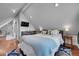 Bright bedroom with a television, colorful rug, bedside table, and modern decor at 1208 S Pennsylvania St, Denver, CO 80210