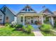 Charming home featuring a covered front porch and well-maintained lawn at 1208 S Pennsylvania St, Denver, CO 80210