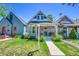 Inviting home with a cozy front porch and lush green lawn at 1208 S Pennsylvania St, Denver, CO 80210