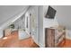 Open hallway area with hardwood floors, storage and television at 1208 S Pennsylvania St, Denver, CO 80210