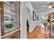Hallway with hardwood floors and white walls leading to living spaces of the home at 1208 S Pennsylvania St, Denver, CO 80210