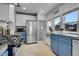 Kitchen features white upper and blue lower cabinets and stainless steel appliances at 1208 S Pennsylvania St, Denver, CO 80210