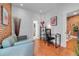 Bright room featuring hardwood floors, exposed brick and modern decor throughout the room at 1208 S Pennsylvania St, Denver, CO 80210