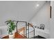 Modern staircase features wood steps, metal railings, and bright, natural light at 1208 S Pennsylvania St, Denver, CO 80210