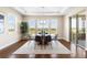 Sunlit dining room with modern light fixture and expansive windows overlooking the backyard at 22609 E Eads Cir, Aurora, CO 80016