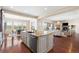 Open-concept kitchen and living space features a large kitchen island, a dining area, and a cozy living room at 22609 E Eads Cir, Aurora, CO 80016