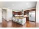 Gourmet kitchen features custom cabinets, granite countertops, stainless appliances and island seating at 22609 E Eads Cir, Aurora, CO 80016