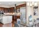 Kitchen and dining area featuring stainless appliances, custom cabinetry, and a modern light fixture at 22609 E Eads Cir, Aurora, CO 80016