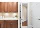 Laundry room with built-in cabinets, sink and view of the hallway at 22609 E Eads Cir, Aurora, CO 80016
