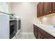 Laundry room with modern washer and dryer, sink, and storage cabinets at 22609 E Eads Cir, Aurora, CO 80016