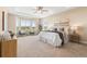 Spacious main bedroom with bay window, tray ceiling, and neutral decor with carpeted floors at 22609 E Eads Cir, Aurora, CO 80016