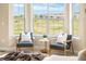 This main bedroom sitting area features beautiful views and cozy seating, carpet flooring and neutral colors at 22609 E Eads Cir, Aurora, CO 80016