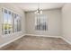 Bright dining room featuring neutral walls, plush carpeting, and natural light from multiple windows at 22646 E Glidden Dr, Aurora, CO 80016