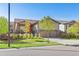 Inviting curb appeal with lush landscaping, beautiful trees, and a cozy front porch with an orange front door at 22646 E Glidden Dr, Aurora, CO 80016