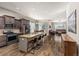Modern open-concept kitchen featuring a large island with bar seating and hardwood floors throughout the home at 22646 E Glidden Dr, Aurora, CO 80016