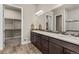 Spacious bathroom featuring double vanity, walk-in closet and neutral tiling at 22646 E Glidden Dr, Aurora, CO 80016