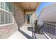 Covered patio area with stone accent wall, perfect for outdoor relaxation and entertaining at 22646 E Glidden Dr, Aurora, CO 80016