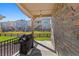 Covered patio with a stone wall overlooking the backyard and neighboring homes at 22646 E Glidden Dr, Aurora, CO 80016