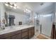 Bright bathroom showcasing double sinks, a glass shower, and neutral tile at 11442 Booth Falls Ct, Parker, CO 80134