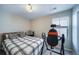 Cozy bedroom with a plaid comforter, gray carpet, and natural light at 11442 Booth Falls Ct, Parker, CO 80134