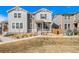 Exterior of a two-story townhome with gray siding, complemented by well-maintained landscaping at 11442 Booth Falls Ct, Parker, CO 80134