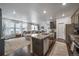Open-concept kitchen and living area featuring granite countertops, stainless steel appliances, and abundant natural light at 11442 Booth Falls Ct, Parker, CO 80134
