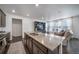 Modern kitchen with a large island, stainless steel appliances, and an open floor plan to the living room at 11442 Booth Falls Ct, Parker, CO 80134