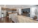 Open floor plan showcasing a modern kitchen, living room with a built-in entertainment unit, and hardwood floors at 11442 Booth Falls Ct, Parker, CO 80134