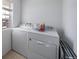 Practical laundry room featuring a washer, dryer, and natural light from the window at 11442 Booth Falls Ct, Parker, CO 80134