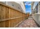 Home's side yard shows a brick paver walkway, wood fence, and space for outdoor activities at 11442 Booth Falls Ct, Parker, CO 80134