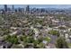 Aerial view of a neighborhood featuring city skyline views and mature trees at 2643 N Marion St, Denver, CO 80205