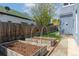 Backyard view featuring raised garden beds with mulch, ready for planting at 2643 N Marion St, Denver, CO 80205
