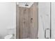 Modern bathroom featuring a tile shower with glass door and a rainfall showerhead at 2643 N Marion St, Denver, CO 80205