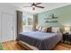 A bright bedroom features hardwood floors, a ceiling fan, and a queen size bed at 2643 N Marion St, Denver, CO 80205