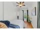 A bright bedroom features hardwood floors and a ceiling fan at 2643 N Marion St, Denver, CO 80205