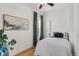 Cozy bedroom with hardwood floors, a ceiling fan, and ample natural light at 2643 N Marion St, Denver, CO 80205