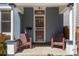 Inviting front porch with two chairs and classic screened front door at 2643 N Marion St, Denver, CO 80205
