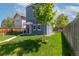 Charming two-story home with landscaped yard and lovely tree in the front at 2643 N Marion St, Denver, CO 80205