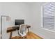 Bright home office space with wood floors, a modern desk, and a large window at 2643 N Marion St, Denver, CO 80205