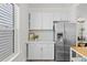 Kitchen featuring white cabinetry, stainless steel refrigerator, and open layout at 2643 N Marion St, Denver, CO 80205