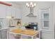 Charming kitchen with white cabinets, stainless steel appliances, and butcher block island at 2643 N Marion St, Denver, CO 80205