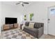Cozy living area with vaulted ceilings, a ceiling fan, and natural light at 2643 N Marion St, Denver, CO 80205