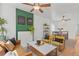 Inviting living room featuring bright yellow chairs, modern decor, and hardwood floors at 2643 N Marion St, Denver, CO 80205