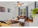 Cozy living room featuring a leather sofa, fireplace, and plenty of natural light at 2643 N Marion St, Denver, CO 80205