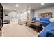 Finished basement with blue sofa, seating area and exercise equipment at 4529 Vrain St, Denver, CO 80212