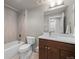 Modern bathroom with a shower and tub combination and a dark wood vanity at 4529 Vrain St, Denver, CO 80212