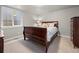 Cozy bedroom with a wood sleigh bed and soft lighting, creating a warm atmosphere at 4529 Vrain St, Denver, CO 80212