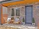 Inviting front porch with stone facade, featuring a seating area and modern front door at 4529 Vrain St, Denver, CO 80212